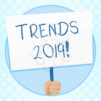 Conceptual hand writing showing Trends 2019. Concept meaning general direction in which something is developing or changing Hand Holding Placard Supported by Handle Social Awareness