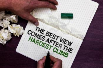 Text sign showing The Best View Comes After The Hardest Climb. Conceptual photo reaching dreams takes effort Man holding marker notebook page crumpled papers several tries mistakes