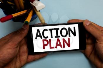 Conceptual hand writing showing Action Plan. Business photo showcasing list of things or schedule to be made thia current year Man holding cell phone looking messages apps cup markers