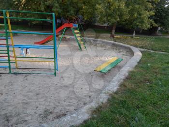Children playground, swing near the house