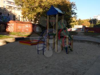 Children playground, swing near the house