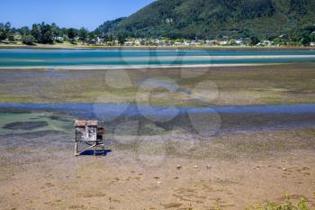 Old wooden fishing hut on stilts at Kairua inlet