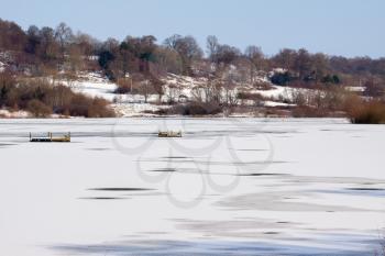 Snow laying on the ice at Weir Wood Reservoir near East Grinstead