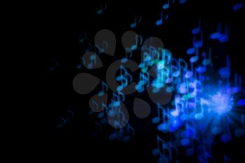 Defocused background with colorful bokeh in a shape of a music notes.