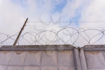 Reinforced concrete fence with barbed wire for above.