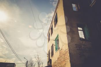 Old crumbling brick house, abandoned building vintage background.