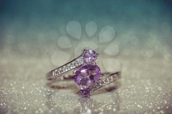 Fashion silver ring decorated with natural amethyst gemstone filtered.