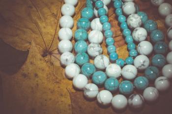 Beads with natural stone blue and white turquoise close up filtered colors.