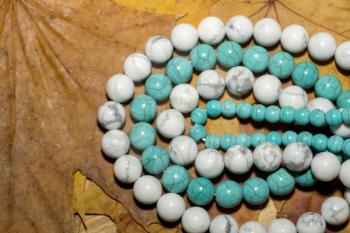 Beads with natural stone blue and white turquoise close up.