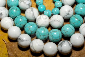 Beads with natural stone blue and white turquoise close up.