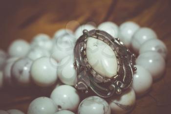 Beads with natural stone white turquoise close up filtered background.