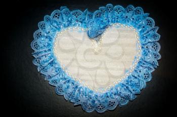 Handmade gift, heart decorated with lace ribbon background.