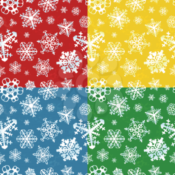 Set of four different colour modern winter seamless patterns with snowflakes