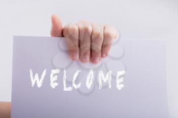 Hand holding welcome word on a white background