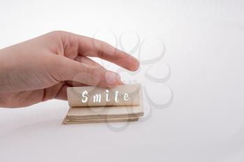 Smile text on paper on a white background