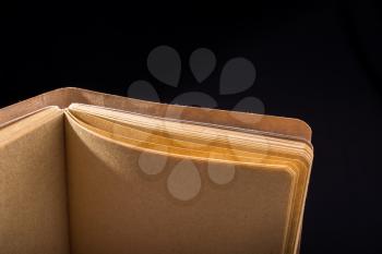 Brown color notebook open on a black background