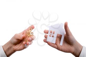 Hand holding an isolated paper house with a white background
