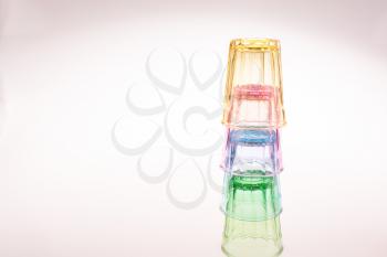 Colorful drinking glasses on white background