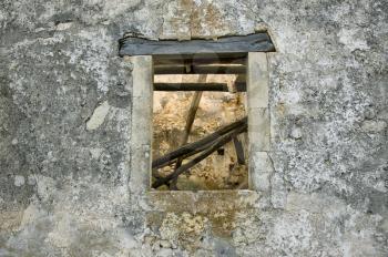 Stone wall and window detail. Abandoned house exterior.