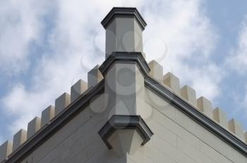 19th century building decorated with tower battlements. Architectural detail.