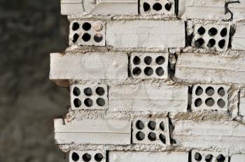 Broken grungy white brick wall background texture.