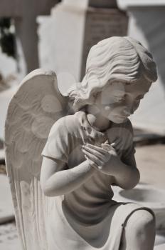 Praying angel marble funerary statue. Mourning cherub abstract.