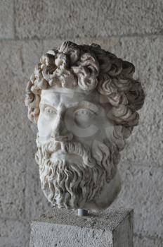 Head of bearded man portrait greek statue marble bust at the ancient agora of Athens, Greece.