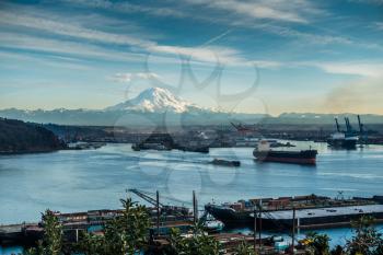 A view of moored boats in the Port of Tacoma with Mount Rainier in the distance.