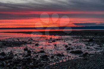 The sun sets along the shoreline in Burien, Washington.