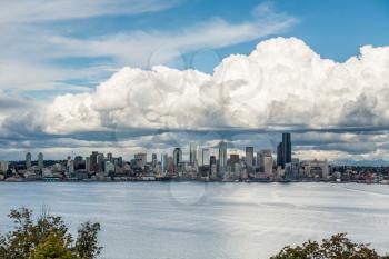 Billowing clouds hover over the Seattle skyline.