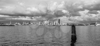 Billowing clouds hover over the Seattle skyline. Black and white image.