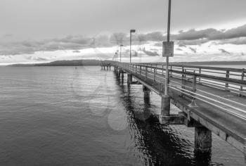 A view of the pier in Des Mointes, Washington. Black and white image.