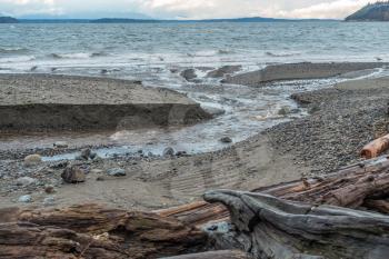 A stream flows across the shoreline at Seahurst Park on its way to the Puget Sound. Photo take in Burien, Washington.