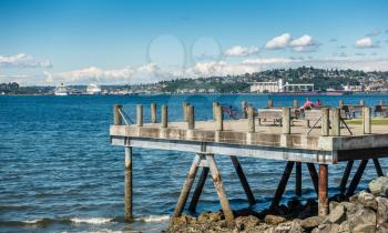 A West Seattle pier looks out toward docked cruise ships in Seattle, Washington.
