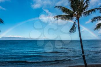 A view of a rainbow over the ocean in Maui, Hawaii.