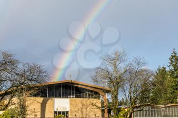 A rainbow ends at a church in Burien, Washington.