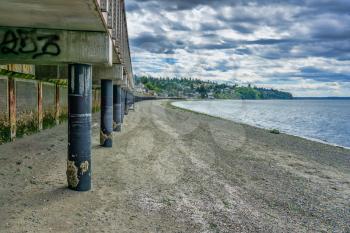 A view from beneath the boardwalk at Redondo Beach, Washington. The tide is low.
