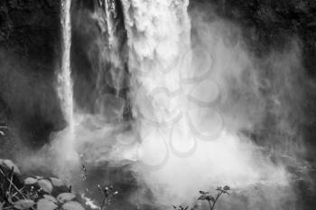 Water explodes into a waterfall in Snoqualmie, Washington. Black and white image.