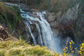 Rays of sunlight shine on Snoqualmie Falls in Washington State.
