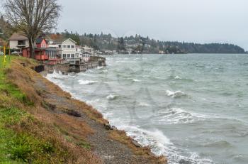 View of shoreline homes in West Seattle, Washington on a stormy day.