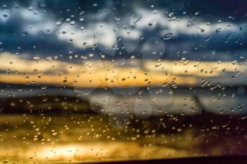 Raindrops cling to a car windshield at the end of the day in Burien, Washington.