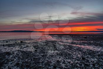 The sun sets along the shoreline in Burien, Washington.