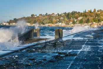 Waves crash onto the shore at Alki Beach in West Seattle, Washington.