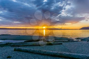 A brilliant golden sunset at Seahurst Beach in Burien, Washington.