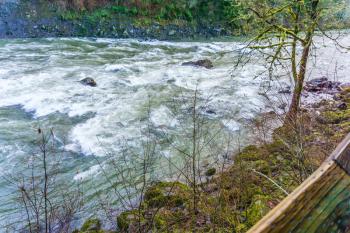 Water rushes along in the Snoqualmie River in Washington State.