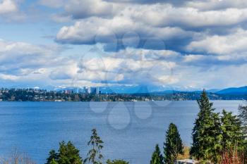 A view of the shoreline of Bellevue, Washington with the Cascade Mountains behind.