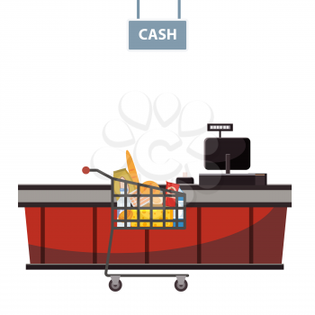 Cashier counter in the supermarket, shop, store with grocery cart full of groceries