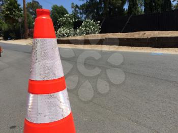Traffic safety cone on road background with trees