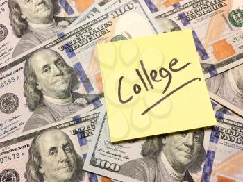 Post it note with hardwritten college on money straight on view with text space on left