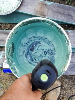 Aqua blue green turquoise paint mixed in bucket home repair improvement